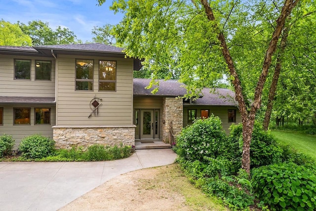 E4725 Riverside Dr, Spring Green, WI 53588 - view of front of home with stone siding and roof with shingles
