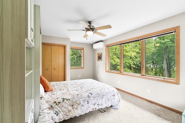 E4725 Riverside Dr, Spring Green, WI 53588 - carpeted bedroom featuring a wall unit AC, a closet, baseboards, and a ceiling fan