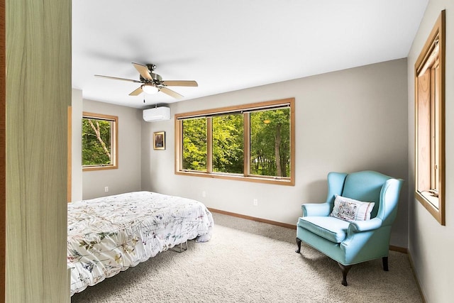 E4725 Riverside Dr, Spring Green, WI 53588 - carpeted bedroom featuring an AC wall unit, baseboards, a closet, and a ceiling fan