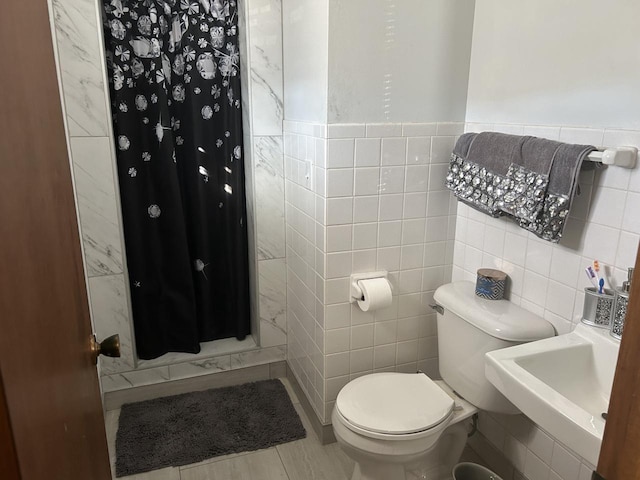 bathroom featuring sink, tile walls, toilet, tile patterned floors, and a shower with curtain