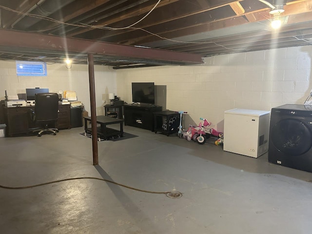 basement featuring refrigerator and washer and clothes dryer