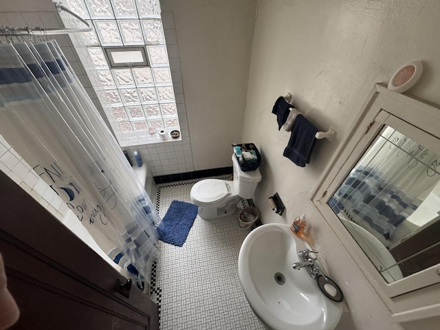 bathroom featuring tile patterned floors, toilet, and sink