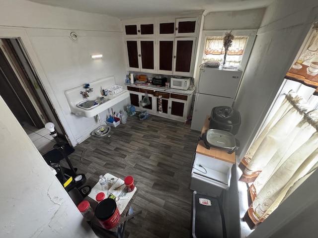 interior space with dark hardwood / wood-style flooring and white appliances