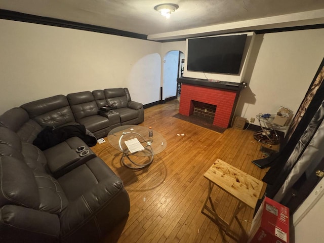 living room featuring hardwood / wood-style floors and a brick fireplace