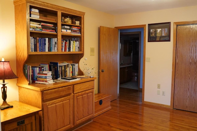 corridor with hardwood / wood-style floors