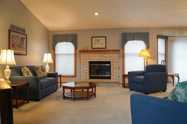 living room with light carpet, a fireplace, and lofted ceiling