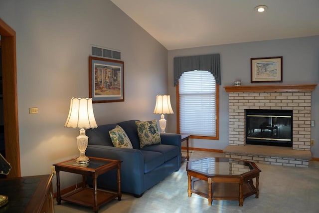 carpeted living room featuring vaulted ceiling and a brick fireplace