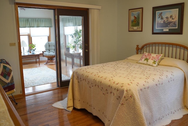 bedroom with hardwood / wood-style flooring and access to exterior