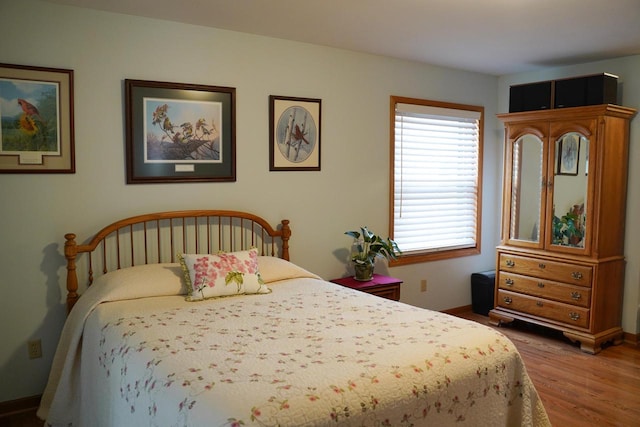 bedroom with hardwood / wood-style floors