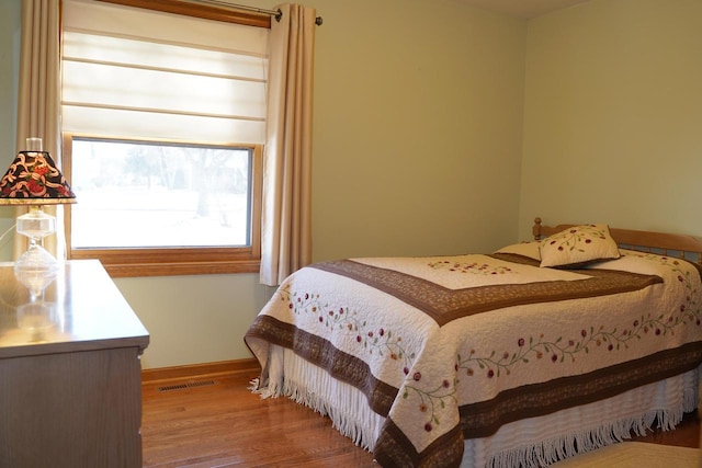 bedroom with hardwood / wood-style floors