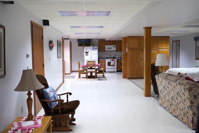 living room with a paneled ceiling