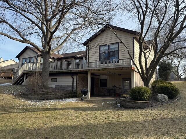 back of house with a patio area, a lawn, and a deck