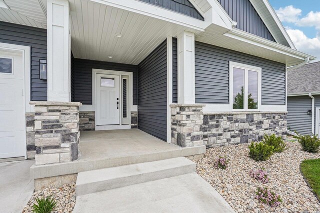 1404 Schoepp Ln, Cross Plains, WI 53528 - entrance to property featuring stone siding, a porch, and board and batten siding