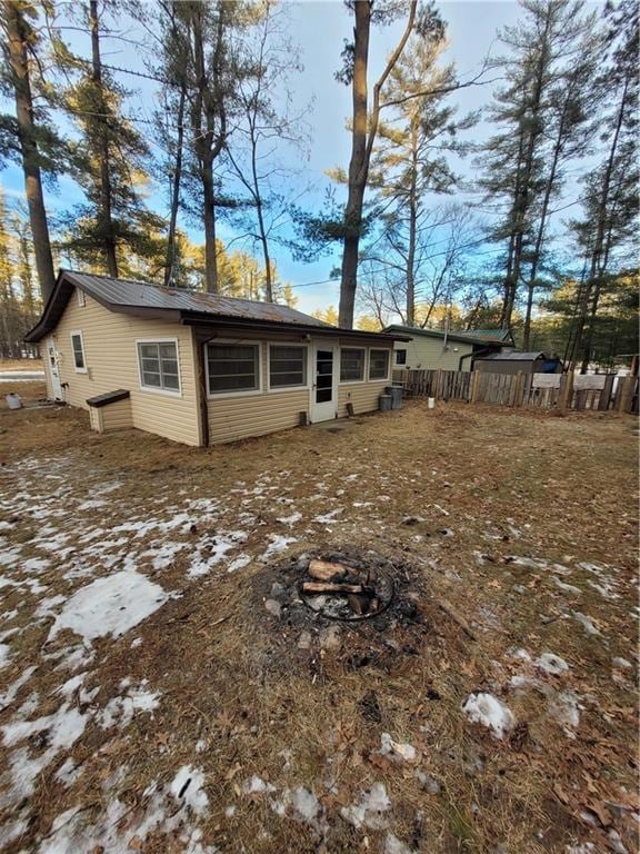 snow covered house with a fire pit