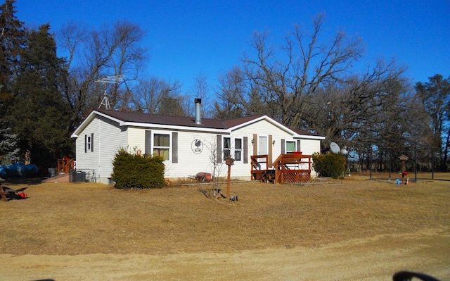 manufactured / mobile home with a front yard and central air condition unit