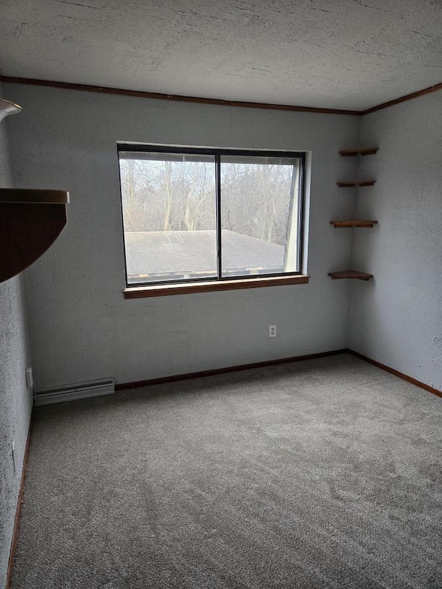 carpeted spare room featuring ornamental molding and a textured ceiling