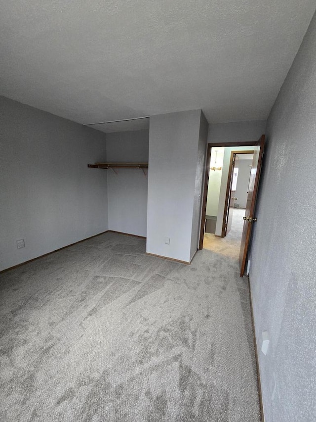 carpeted spare room with a textured ceiling