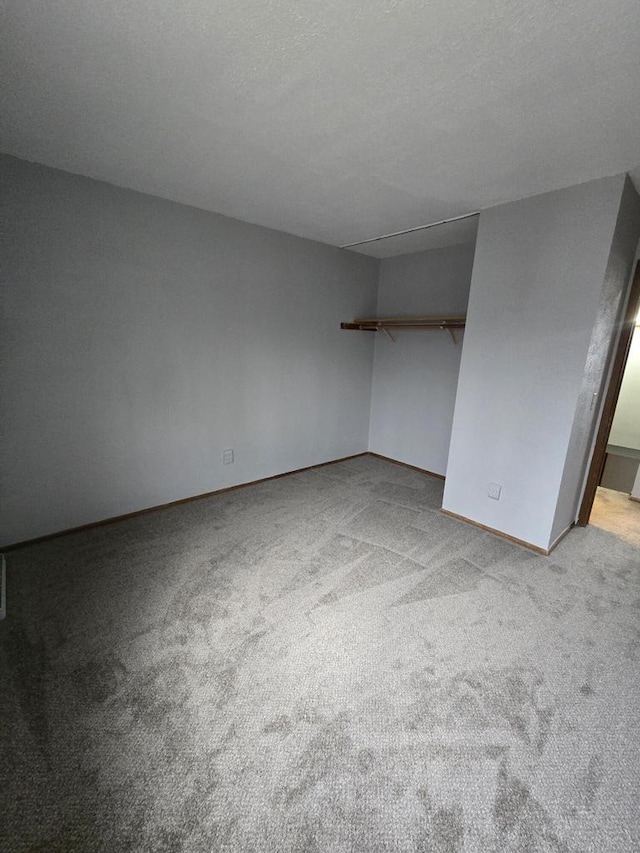 unfurnished bedroom featuring light colored carpet and a textured ceiling