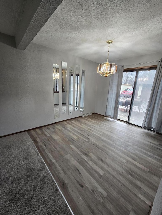 interior space with wood-type flooring, a chandelier, and a textured ceiling