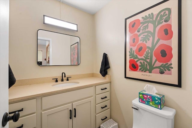 bathroom with toilet and vanity