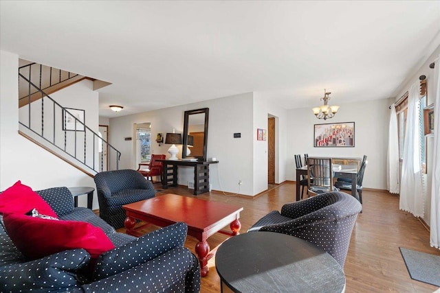 living area featuring a wealth of natural light, stairway, and wood finished floors