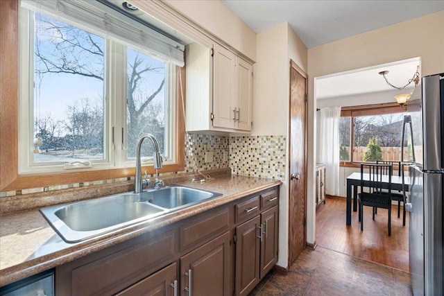 kitchen with a sink, tasteful backsplash, and appliances with stainless steel finishes