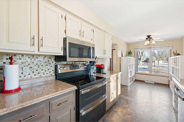 kitchen featuring tasteful backsplash, visible vents, light countertops, appliances with stainless steel finishes, and a ceiling fan