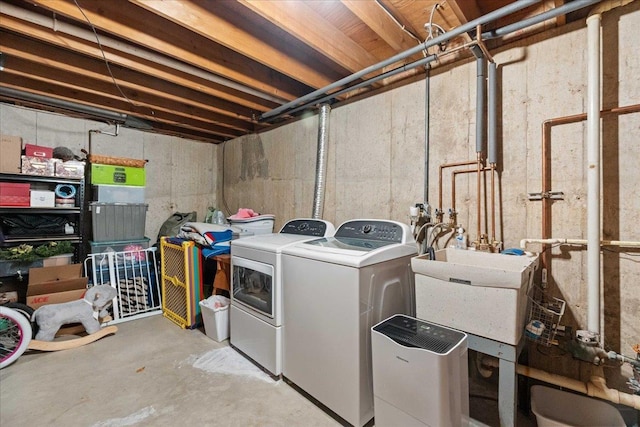 laundry room featuring washer and dryer, laundry area, and a sink