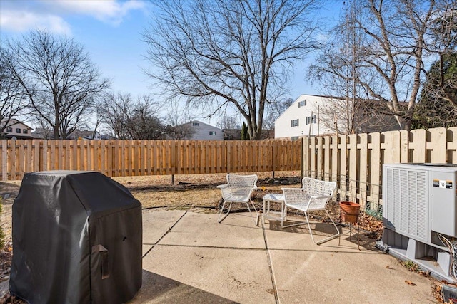 view of patio with central air condition unit, a fenced backyard, and area for grilling