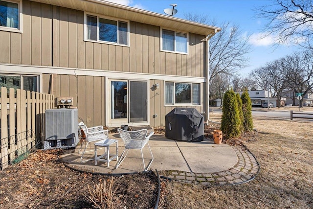 rear view of property featuring a patio area, cooling unit, and fence