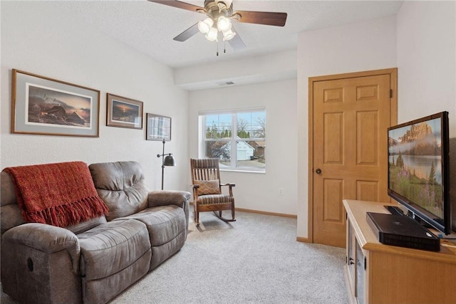 carpeted living room with ceiling fan