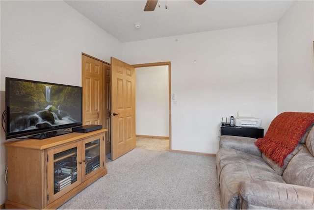 carpeted living room with ceiling fan