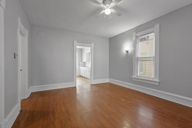 unfurnished room with hardwood / wood-style floors and ceiling fan