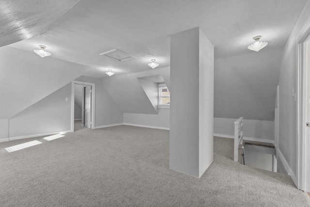 bonus room with lofted ceiling and carpet