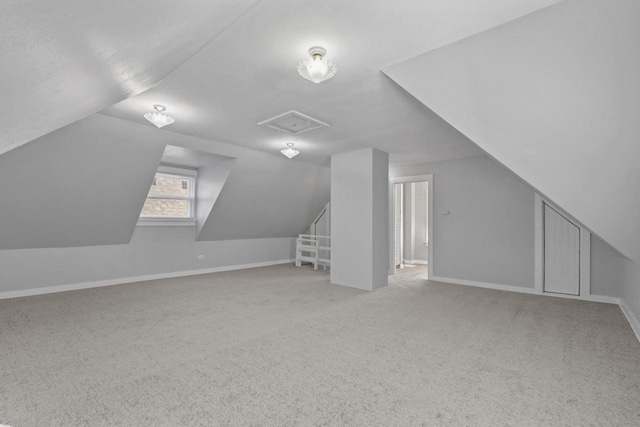 bonus room featuring lofted ceiling and light carpet