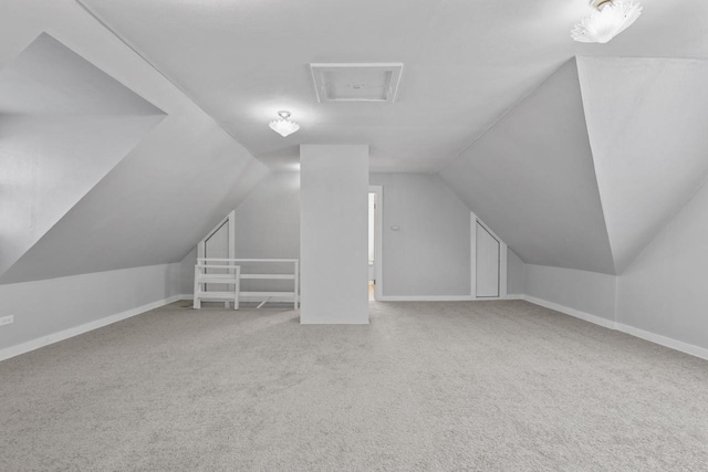 additional living space featuring lofted ceiling and carpet flooring