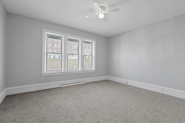 empty room featuring ceiling fan, carpet floors, and a baseboard heating unit