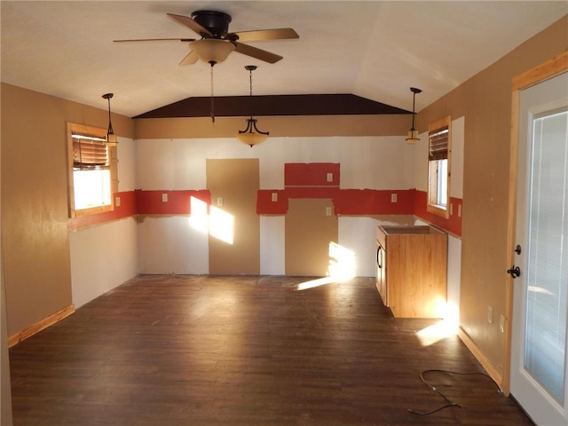 kitchen with vaulted ceiling, dark wood-type flooring, and decorative light fixtures