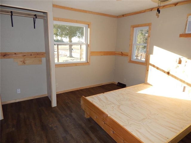 unfurnished bedroom with dark hardwood / wood-style flooring