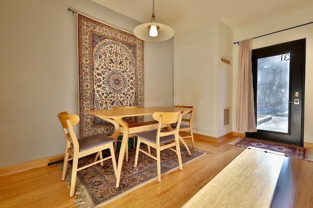 dining space with hardwood / wood-style flooring