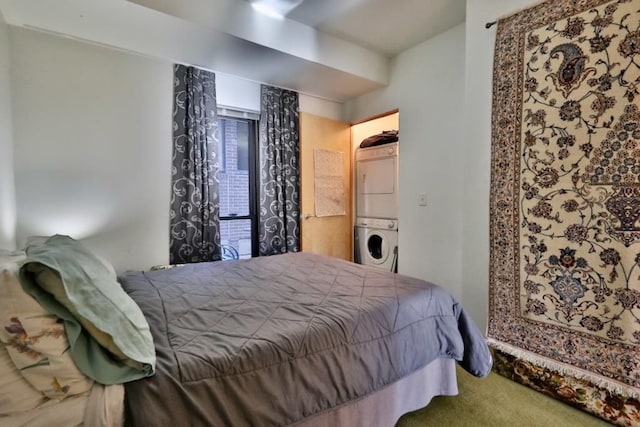 carpeted bedroom featuring stacked washer / dryer