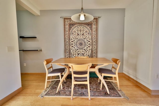 dining area with breakfast area and light hardwood / wood-style floors