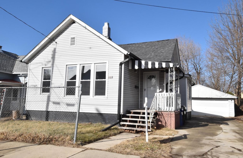 view of front facade with an outbuilding and a garage