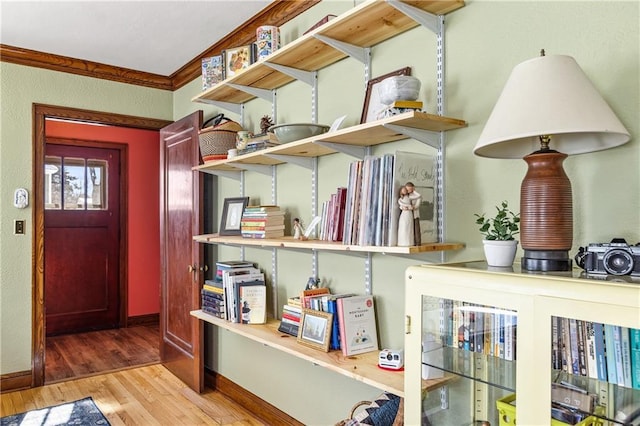 interior details featuring hardwood / wood-style floors and crown molding