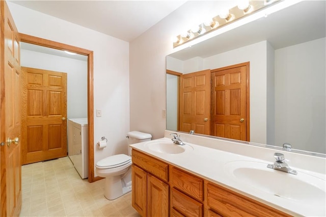 bathroom with vanity, toilet, and washer / clothes dryer