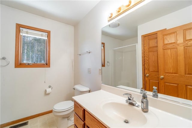 bathroom featuring tile patterned flooring, a shower, vanity, and toilet