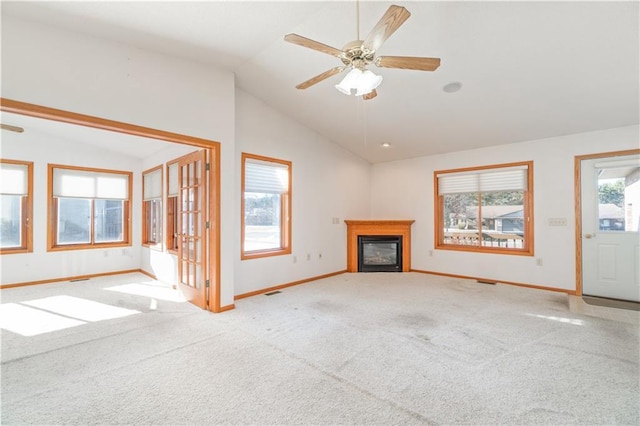 unfurnished living room featuring vaulted ceiling, light colored carpet, and ceiling fan