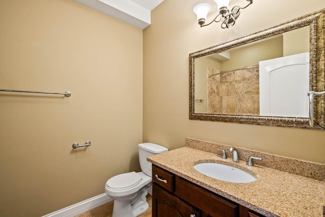 bathroom featuring walk in shower, vanity, and toilet