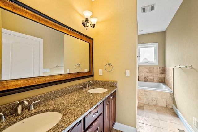 bathroom with vanity and tiled tub