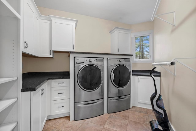 laundry room with washer and dryer and cabinets